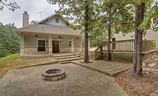 rear view of house with a fire pit, a patio area, ceiling fan, and a deck