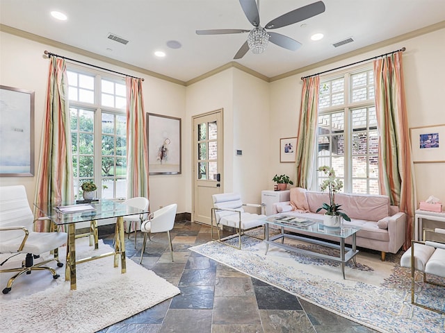 interior space with ceiling fan, ornamental molding, and plenty of natural light