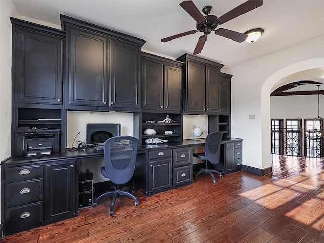 office featuring ceiling fan, dark hardwood / wood-style floors, and built in desk