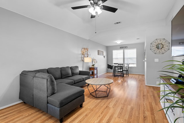 living room with lofted ceiling, light hardwood / wood-style flooring, and ceiling fan