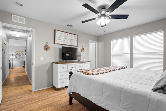 bedroom with ceiling fan and light hardwood / wood-style floors