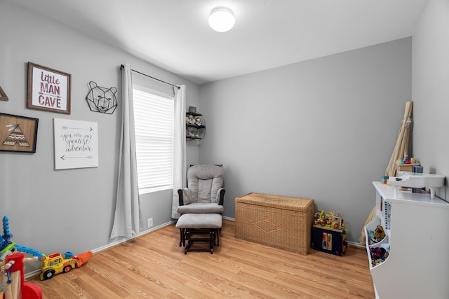 rec room with light hardwood / wood-style floors