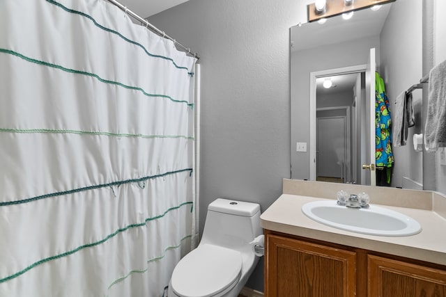 bathroom with vanity, toilet, and a shower with shower curtain