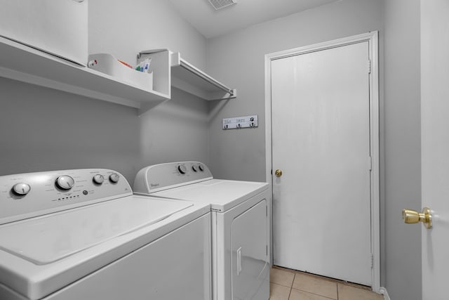 washroom featuring independent washer and dryer and light tile patterned floors