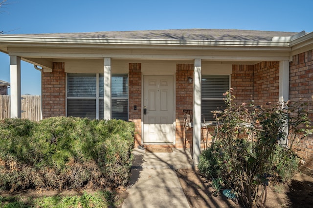 view of exterior entry with covered porch