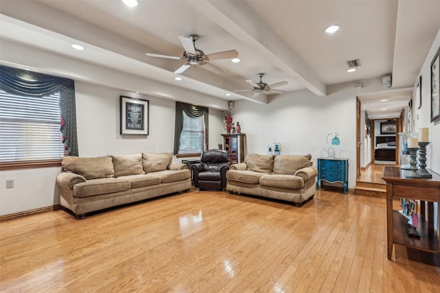 living room with beam ceiling, light hardwood / wood-style flooring, and ceiling fan