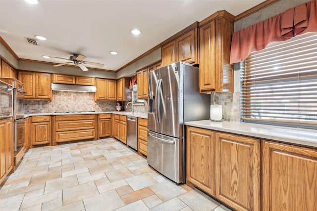 kitchen featuring a healthy amount of sunlight, stainless steel appliances, sink, and decorative backsplash