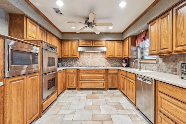 kitchen featuring sink, backsplash, ornamental molding, ceiling fan, and stainless steel appliances