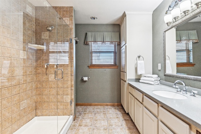 bathroom featuring a shower with door, vanity, and tile patterned flooring