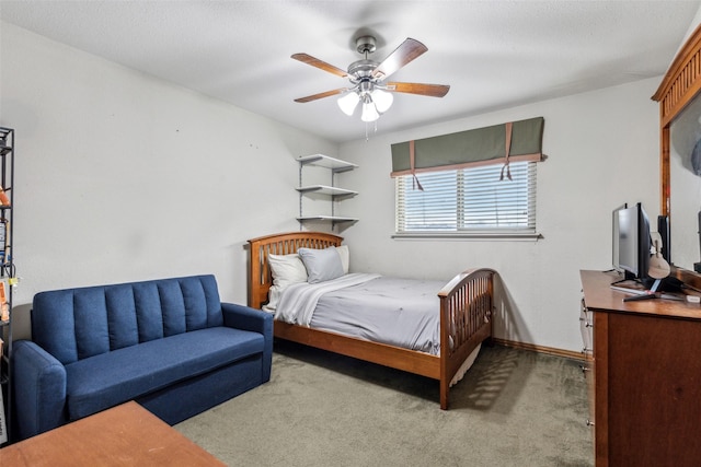 bedroom featuring light carpet, a textured ceiling, and ceiling fan