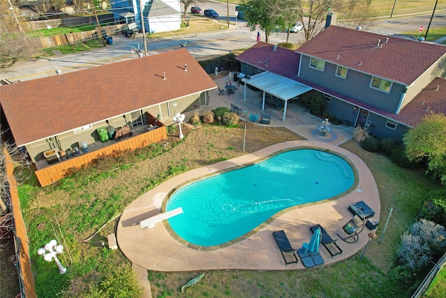 view of pool featuring a diving board and a patio