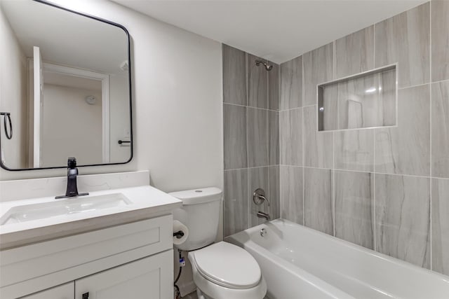 full bathroom with tiled shower / bath, vanity, and toilet