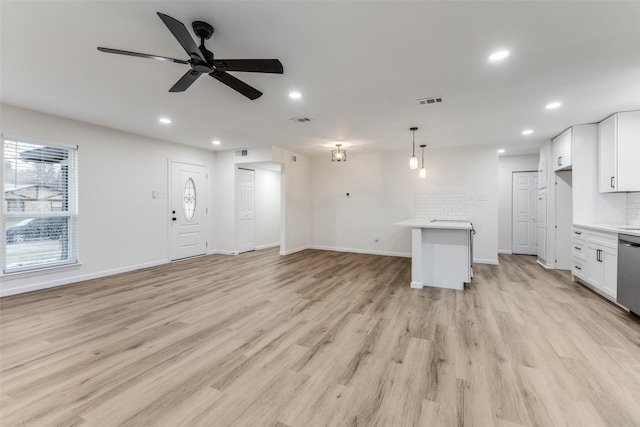 unfurnished living room with ceiling fan and light wood-type flooring