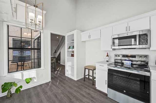 kitchen with white cabinetry, pendant lighting, and stainless steel appliances