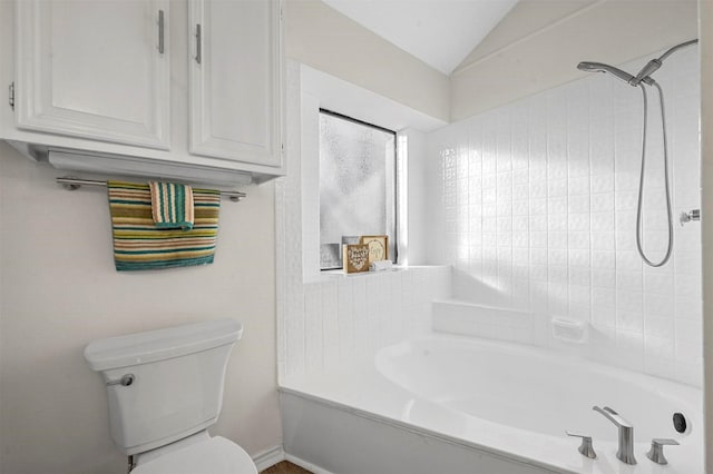 bathroom with lofted ceiling and toilet