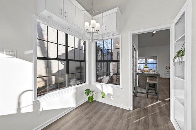 dining space featuring a notable chandelier and dark hardwood / wood-style flooring