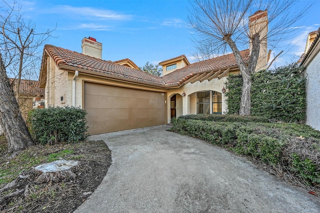 mediterranean / spanish-style home with a garage