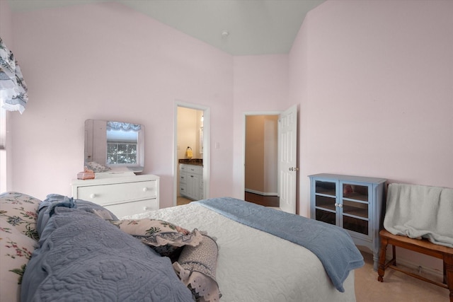 bedroom featuring ensuite bathroom and a towering ceiling