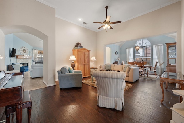 living room with crown molding, ceiling fan, and dark hardwood / wood-style floors