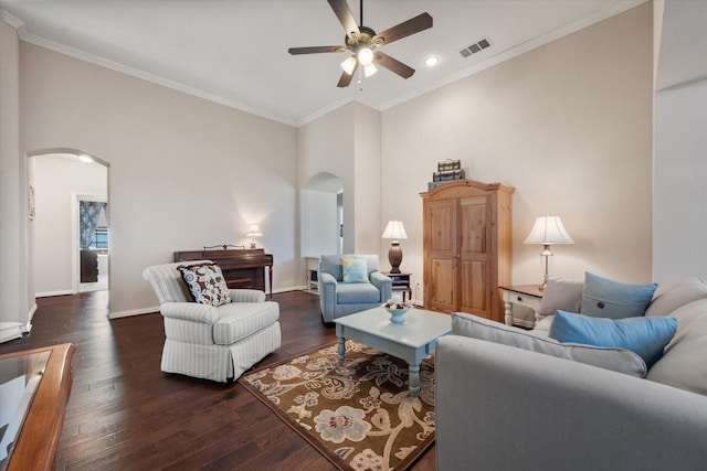 living room with ceiling fan, a high ceiling, crown molding, and dark hardwood / wood-style floors