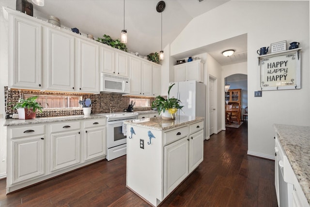 kitchen featuring white cabinetry, decorative light fixtures, light stone countertops, vaulted ceiling, and white appliances