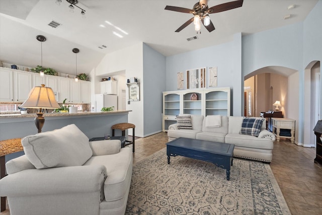 living room featuring ceiling fan and lofted ceiling