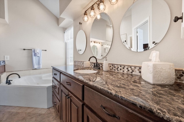 bathroom with a bath, tile patterned floors, and vanity