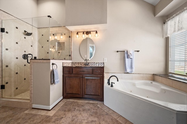 bathroom featuring separate shower and tub and vanity