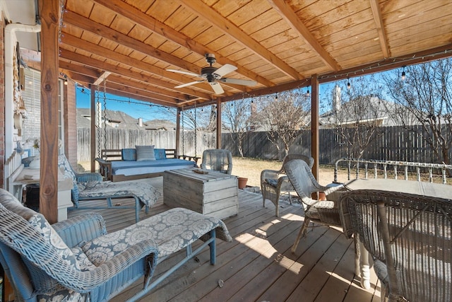 wooden deck featuring outdoor lounge area and ceiling fan