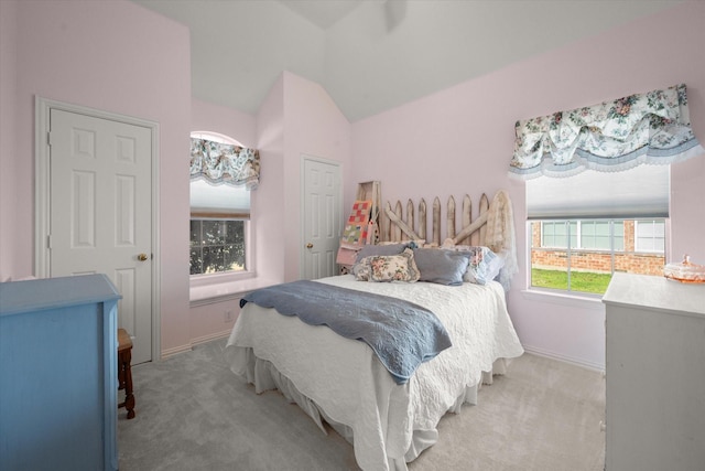 bedroom with vaulted ceiling and light carpet