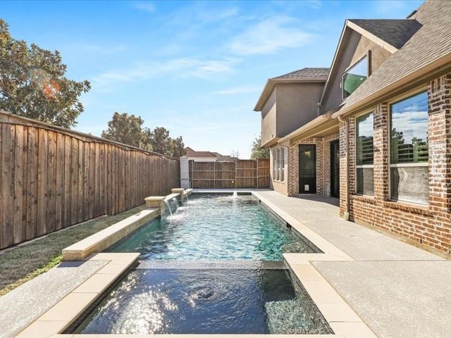 view of pool with pool water feature and a patio