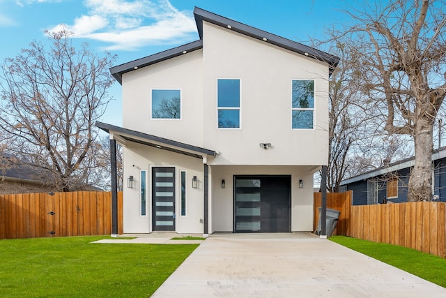 view of front of home with a garage and a front yard