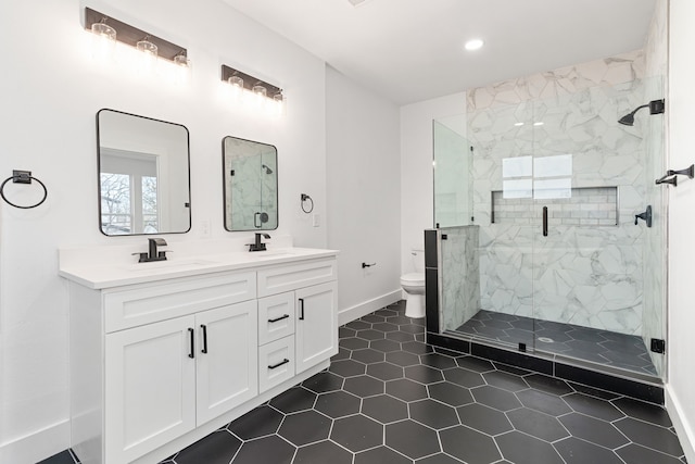 bathroom featuring tile patterned flooring, vanity, toilet, and walk in shower