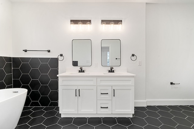 bathroom with vanity, a bathtub, tile patterned floors, and tile walls