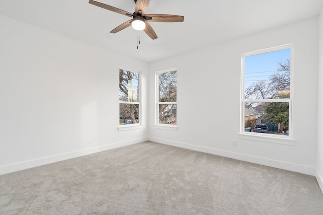 unfurnished room featuring light colored carpet and ceiling fan