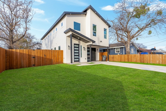 rear view of house featuring a garage and a yard