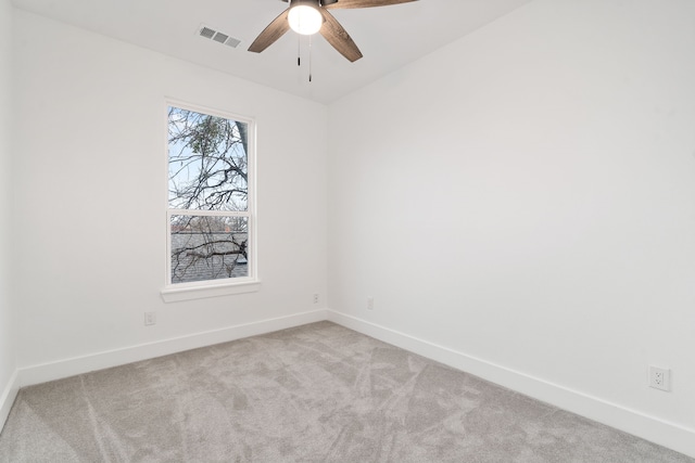 spare room featuring ceiling fan and light carpet