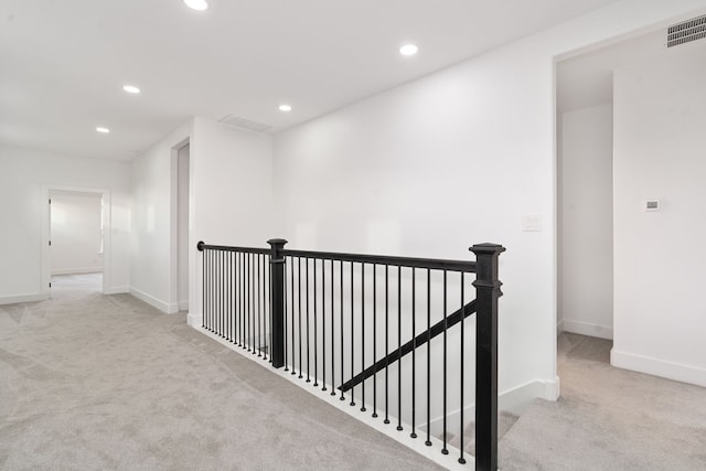 corridor with light colored carpet