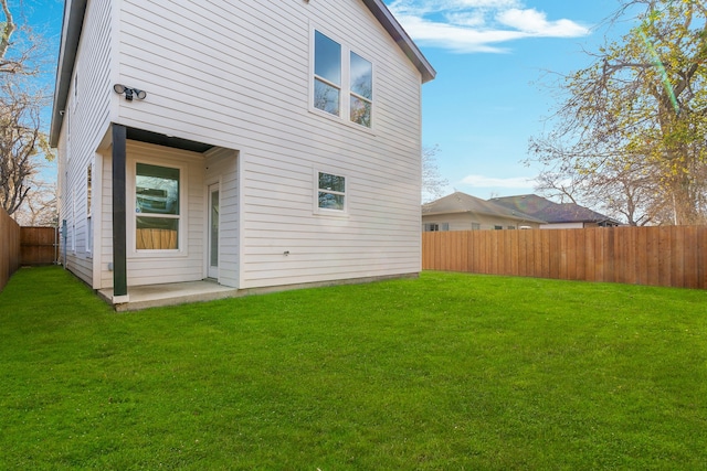 rear view of house featuring a lawn