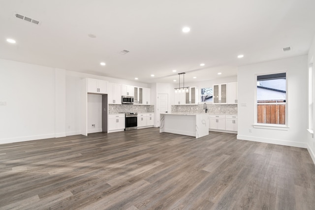 unfurnished living room with dark hardwood / wood-style flooring and sink