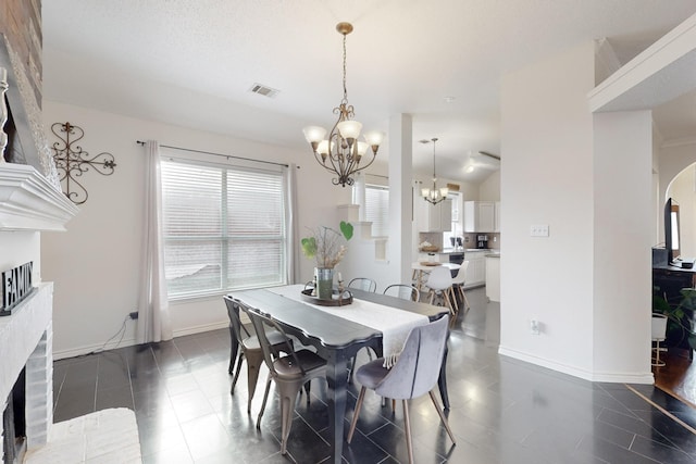 dining area featuring dark tile patterned floors, lofted ceiling, and a chandelier