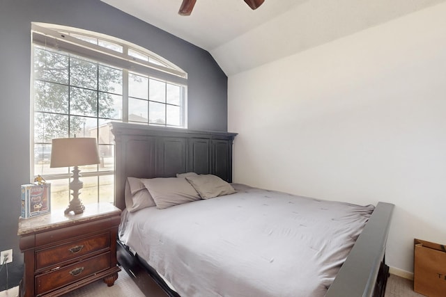 carpeted bedroom with ceiling fan and lofted ceiling