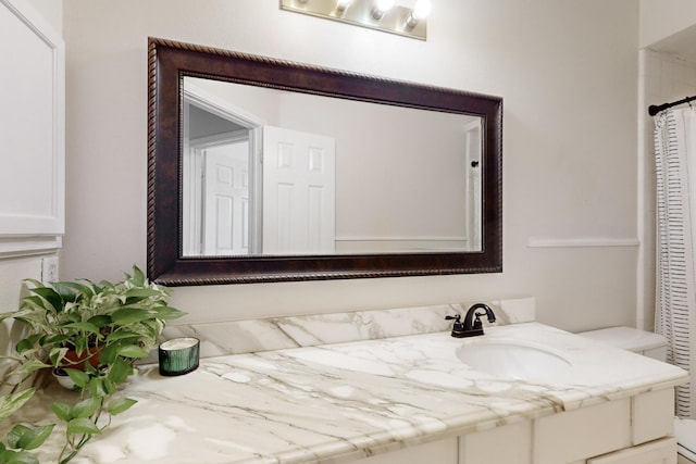 bathroom featuring vanity and curtained shower