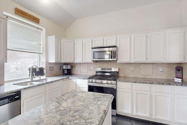 kitchen featuring light stone countertops, appliances with stainless steel finishes, sink, and white cabinets