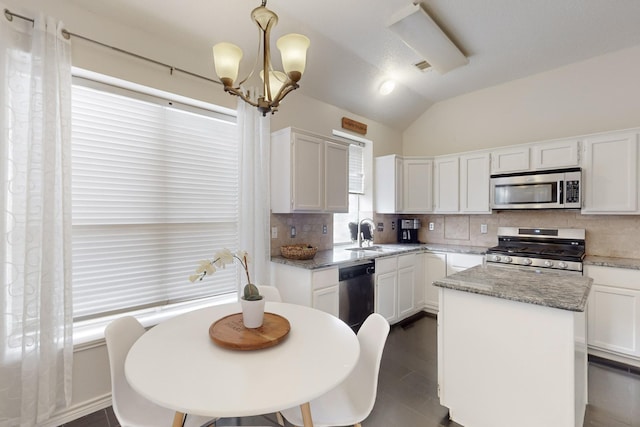 kitchen with stainless steel appliances, hanging light fixtures, a center island, and white cabinets