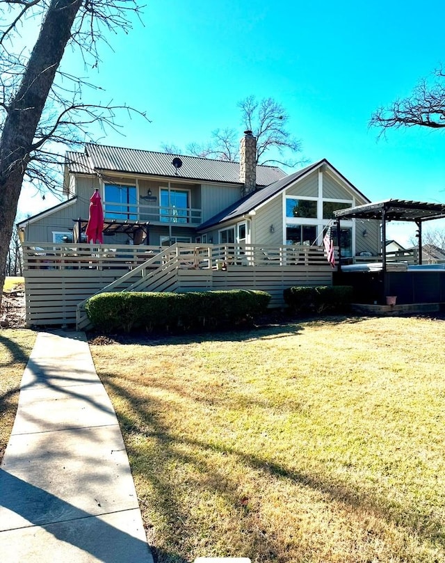 rear view of property featuring a yard and a pergola