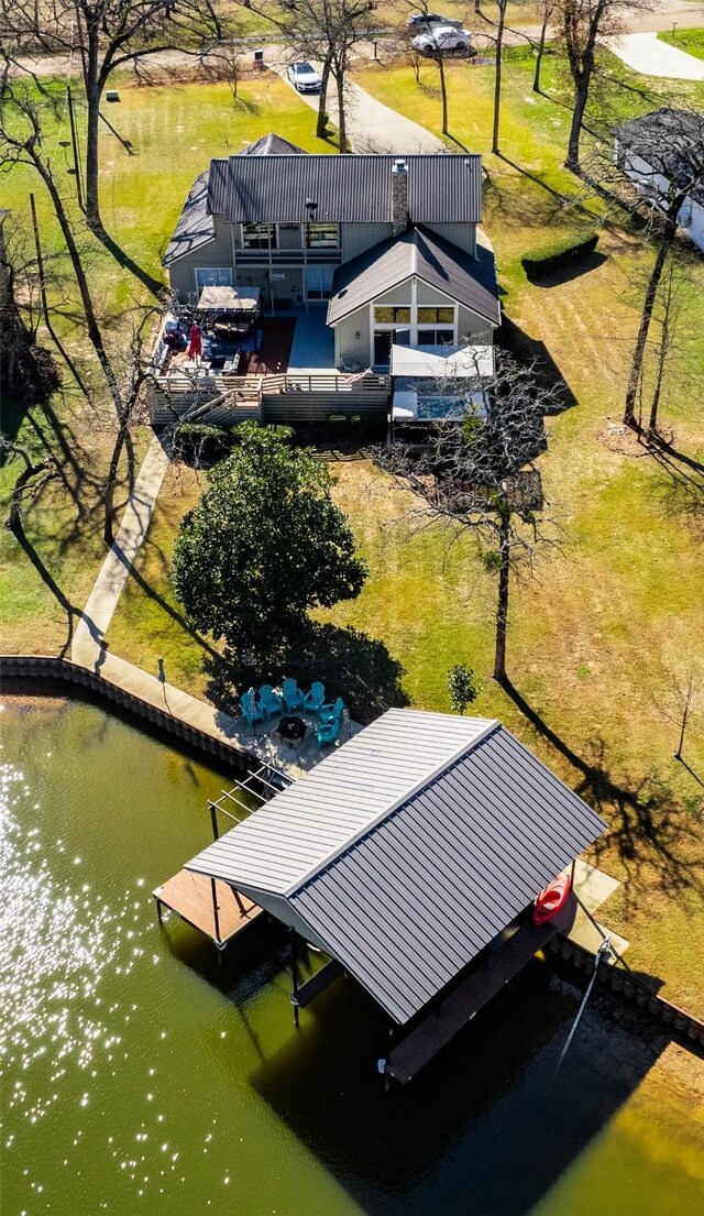 view of dock featuring a water view and a lawn