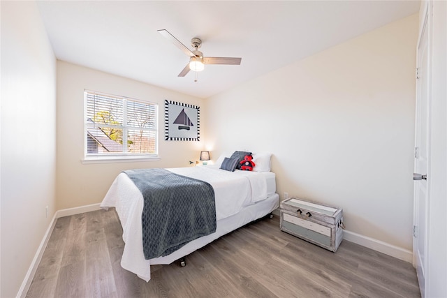 bedroom with light hardwood / wood-style floors and ceiling fan