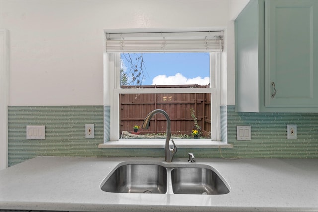 kitchen with tasteful backsplash, sink, and green cabinets