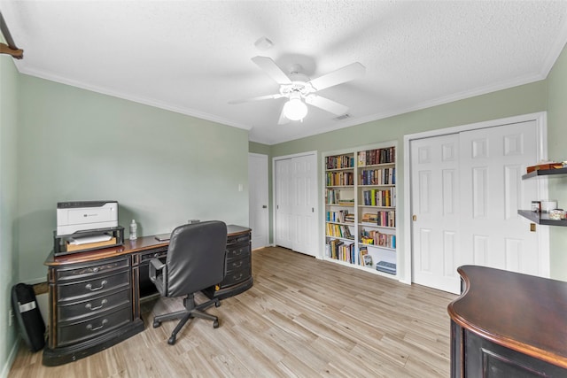 office space with crown molding, ceiling fan, a textured ceiling, and light wood-type flooring